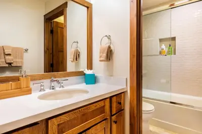 a bathroom with a sink and a toilet and a mirror at Snowcreek 222 in Mammoth Lakes