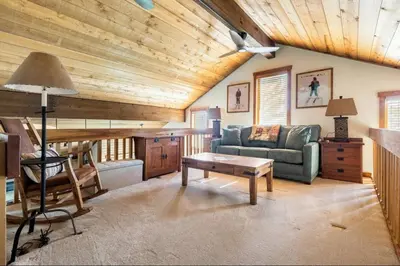 a living room with a couch and a table at Snowcreek 222 in Mammoth Lakes