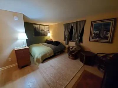 a bedroom with a bed and a table with a lamp at Cozy Room in Rural Markleeville Cabin in Markleeville