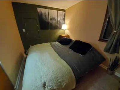 a bedroom with a bed and a lamp in it at Cozy Room in Rural Markleeville Cabin in Markleeville
