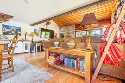 a living room with a couch and a table with books at Snowcreek 315 in Mammoth Lakes