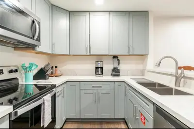 a kitchen with white cabinets and a sink at St. Moritz 39 in Mammoth Lakes