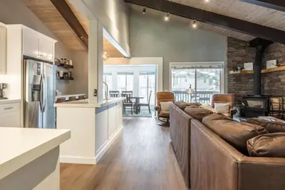 a living room with leather couches and a kitchen and a living room at Chateau Blanc 1 in Mammoth Lakes
