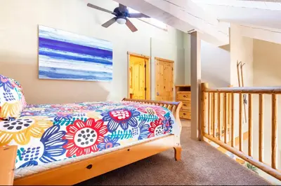 a bedroom with a bed and a ceiling fan at Western Slopes Villas 18 in Mammoth Lakes