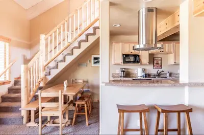 a kitchen and dining room with a wooden table and stairs at Western Slopes Villas 18 in Mammoth Lakes