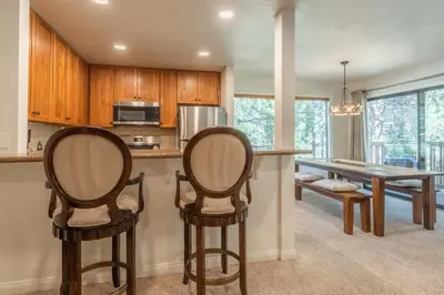 a kitchen with two chairs and a wooden table at Summit 27 in Mammoth Lakes