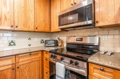a kitchen with a stove and a microwave at Summit 27 in Mammoth Lakes