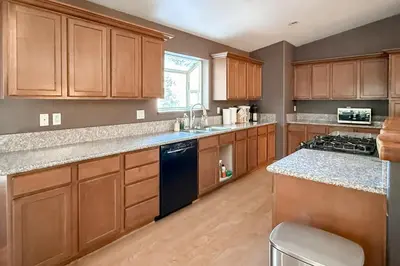a kitchen with wooden cabinets and a blue dishwasher at High Sierra Hideaway in South Lake Tahoe