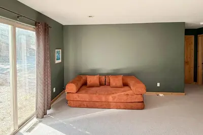 an orange couch in a room with a green wall at High Sierra Hideaway in South Lake Tahoe