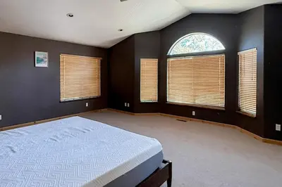 a bedroom with a bed and two windows at High Sierra Hideaway in South Lake Tahoe