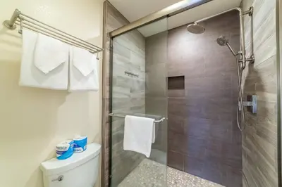 a bathroom with a shower and a toilet at Quaint 1B/1BA Canyon Lodge Condo: Jacuzzi & More! in Mammoth Lakes
