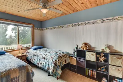 a bedroom with two beds and a ceiling fan at Deck and Wooded Views 5-Acre Auberry Retreat! in Auberry
