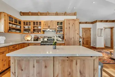 a kitchen with wooden cabinets and a counter top at Cozy Tahoe Getaway - Walk to Lake & Quiet Deck in Carnelian Bay