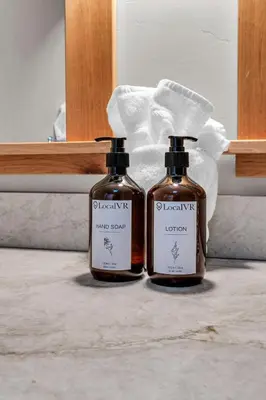two bottles of soap sitting on the floor in a bathroom at Cozy Tahoe Getaway - Walk to Lake & Quiet Deck in Carnelian Bay