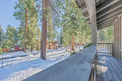 an empty porch of a house in the snow at Cozy Tahoe Getaway - Walk to Lake & Quiet Deck in Carnelian Bay