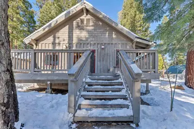 a staircase leading to a cabin in the snow at Cozy Tahoe Getaway - Walk to Lake & Quiet Deck in Carnelian Bay