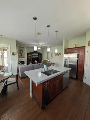 a kitchen with a sink and a living room at Spacious 5-bedroom 3-bath house in NW Fresno in Fresno