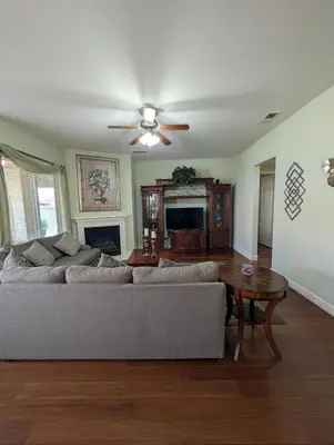 a living room with a couch and a table at Spacious 5-bedroom 3-bath house in NW Fresno in Fresno