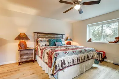 a bedroom with a bed and a ceiling fan at Hot Tub and Huge Patio Home 5 Mi to Old Town Auburn in Auburn
