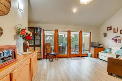 a living room with a couch and a table at Hot Tub and Huge Patio Home 5 Mi to Old Town Auburn in Auburn