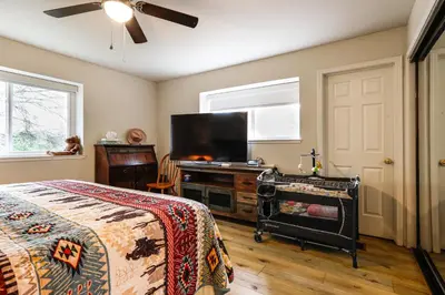 a bedroom with a bed and a flat screen tv at Hot Tub and Huge Patio Home 5 Mi to Old Town Auburn in Auburn