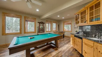 a pool table in the middle of a kitchen at Truckee Mountain Cabin with Hot Tub Game Room Forest Views Gray Wolf Lodge by AvantStay in Truckee