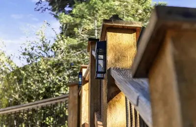 a wooden fence with a light on top of it at Big Foot Hide Out Shaver Lake Mts in Shaver Lake