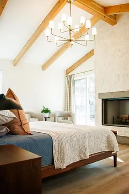 a bedroom with a bed and a chandelier at Quiet retreat - Hot tub & sauna in Three Rivers in Three Rivers