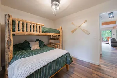 a bedroom with a bunk bed and a ceiling fan at Whispering Pines Cabin For 6 in Carnelian Bay