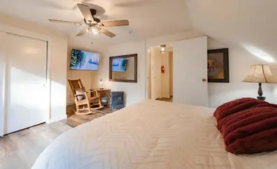 a bedroom with a large bed and a ceiling fan at Whispering Pines Cabin For 6 in Carnelian Bay