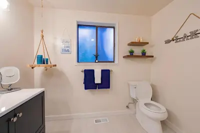 a bathroom with a toilet and a window at Whispering Pines Cabin For 6 in Carnelian Bay