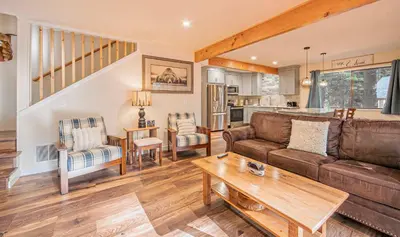 a living room with a couch and a table at Whispering Pines Cabin For 6 in Carnelian Bay