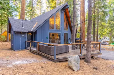 a tiny house in the woods with a deck at Cozy Tahoma Family Cabin in the Pines Sleeps 6 Pets in Tahoma