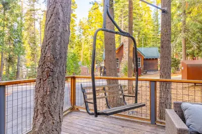 a swing on a deck with a tree at Cozy Tahoma Family Cabin in the Pines Sleeps 6 Pets in Tahoma