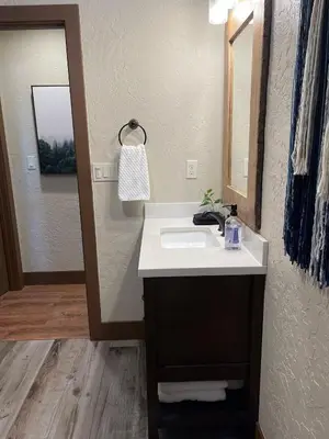a bathroom with a sink and a mirror at The Little Dipper Cabin in Shaver Lake