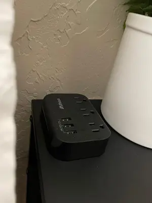 a remote control sitting on a table next to a lamp at The Little Dipper Cabin in Shaver Lake