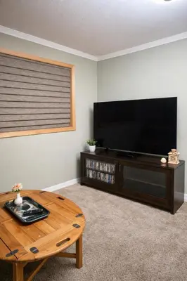 a living room with a flat screen tv and a coffee table at Chamberland retreat-Hot Tub, Pool Table, Movie & Ski in Homewood