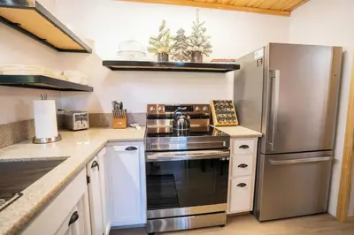 a kitchen with a stainless steel stove and refrigerator at Strawberry Chalet Near Pinecrest & Dodge Ridge in Strawberry