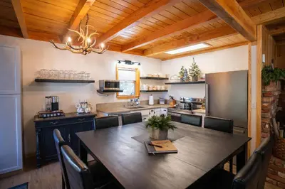 a kitchen with a large wooden table and chairs at Strawberry Chalet Near Pinecrest & Dodge Ridge in Strawberry