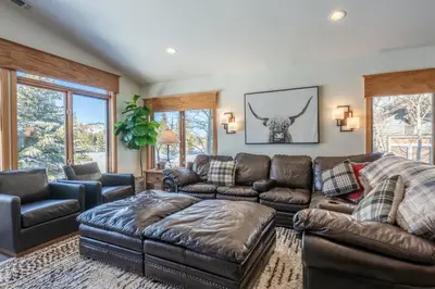 a living room with a leather couch and furniture at Snowcreek 704 in Mammoth Lakes