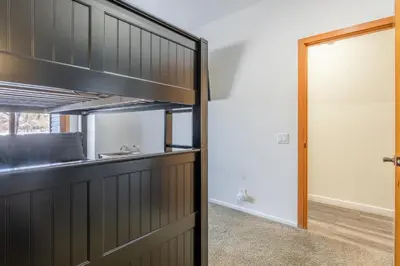a kitchen with a door leading into a room at Snowcreek 704 in Mammoth Lakes