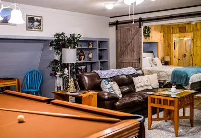 a living room with a pool table and a bed at Red Barn Haven-Your romantic getaway to Yosemite in Oakhurst