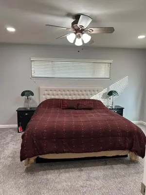 a bedroom with a bed and a ceiling fan at The gorgeous in Citrus Heights