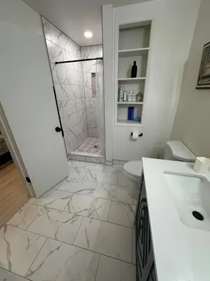 a white bathroom with a shower and a sink at Hidden Gem House incredible location remodeled in South Lake Tahoe