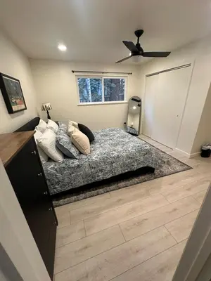 a bedroom with a bed and a ceiling fan at Hidden Gem House incredible location remodeled in South Lake Tahoe