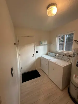 a kitchen with a washer and dryer and a window at Hidden Gem House incredible location remodeled in South Lake Tahoe