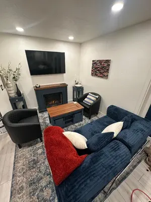 a living room with a blue couch and a fireplace at Hidden Gem House incredible location remodeled in South Lake Tahoe