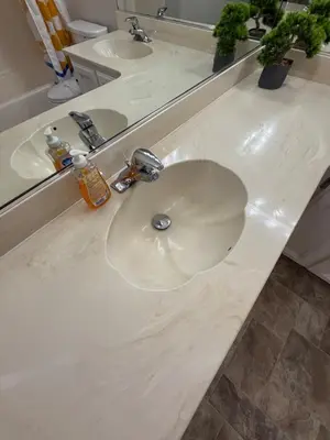 a white bathroom counter with two sinks and a mirror at Spacious 4BR Family Home Free Parking, Fast WiFi, Near Galleria & Fountains in Roseville