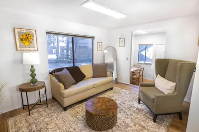 a living room with a couch and a chair at Fox Cabin - Lakefront - Sleeps 4 in Bass Lake
