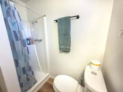 a bathroom with a toilet and a green towel at Fox Cabin - Lakefront - Sleeps 4 in Bass Lake